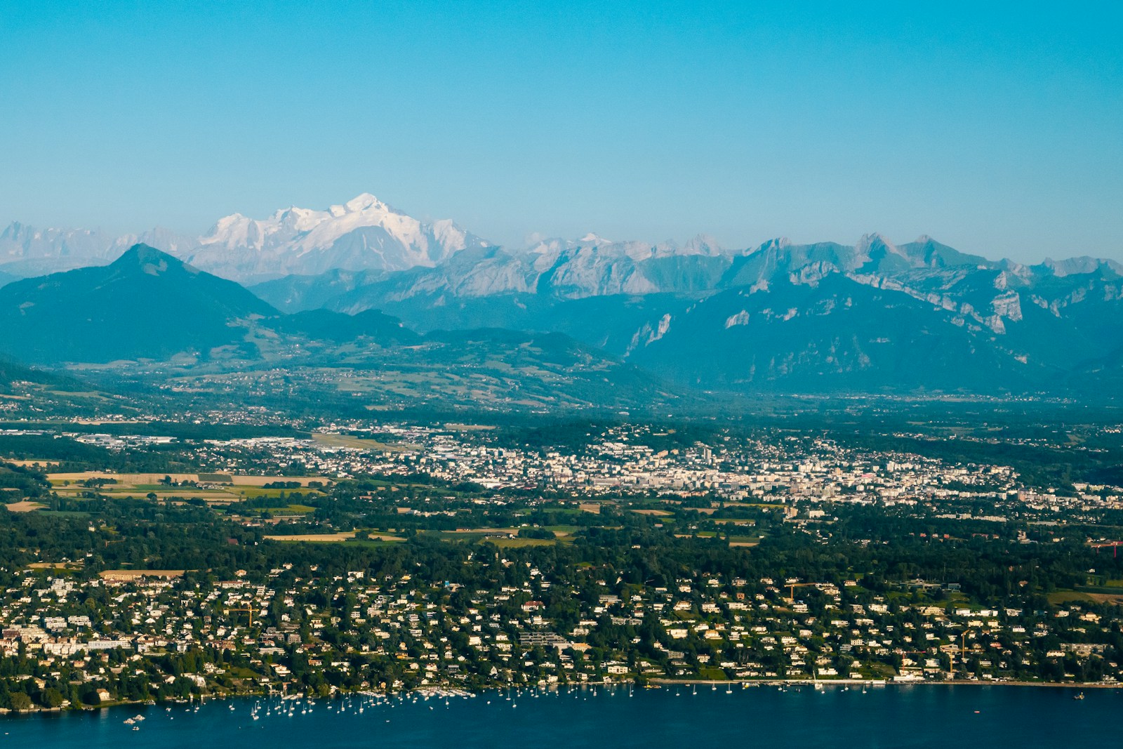 An aerial view of a city with mountains in the background